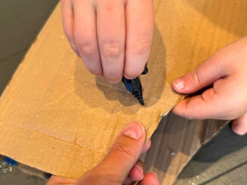 3D-gedrucktes Visier wird an die Kartonform des Ritterhelms geklebt.